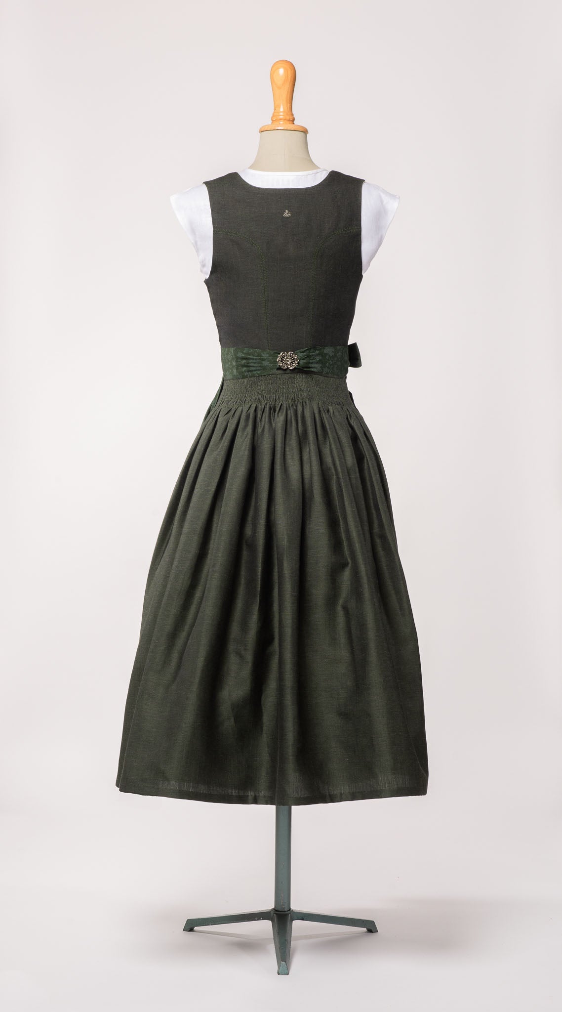 Mieder Ava und Trachtenrock Marlene aus dunkelgrüner Leinen-Schurwolle-Mischung, kombiniert mit farblich passender Schürze – Rückansicht auf Büste, handgefertigt in München von Zirbenfux