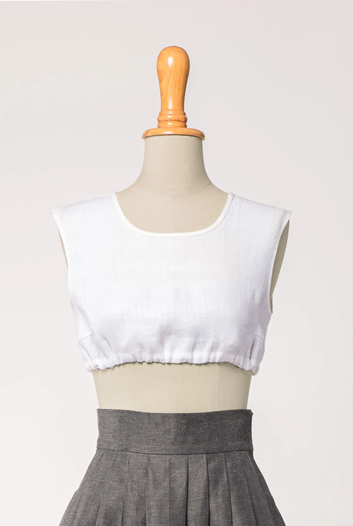 Dirndlbluse Charlie aus weißem Bio-Leinen, kombiniert mit Rock Marlene in Anthrazit – Frontansicht auf Büste, handgefertigt in München von Zirbenfux