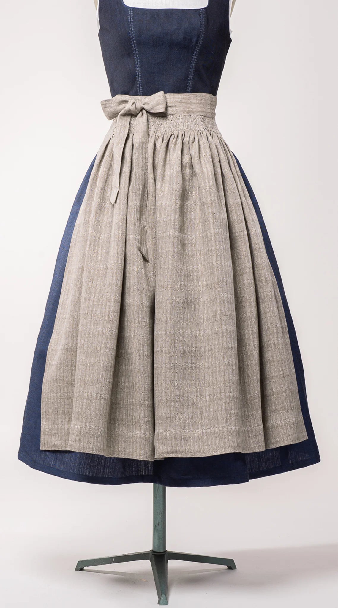 Nahaufnahme Dirndlschürze aus naturfarbenem Bio-Leinen mit eingewebtem Muster – Frontansicht auf Büste, nachhaltig gefertigt von Zirbenfux