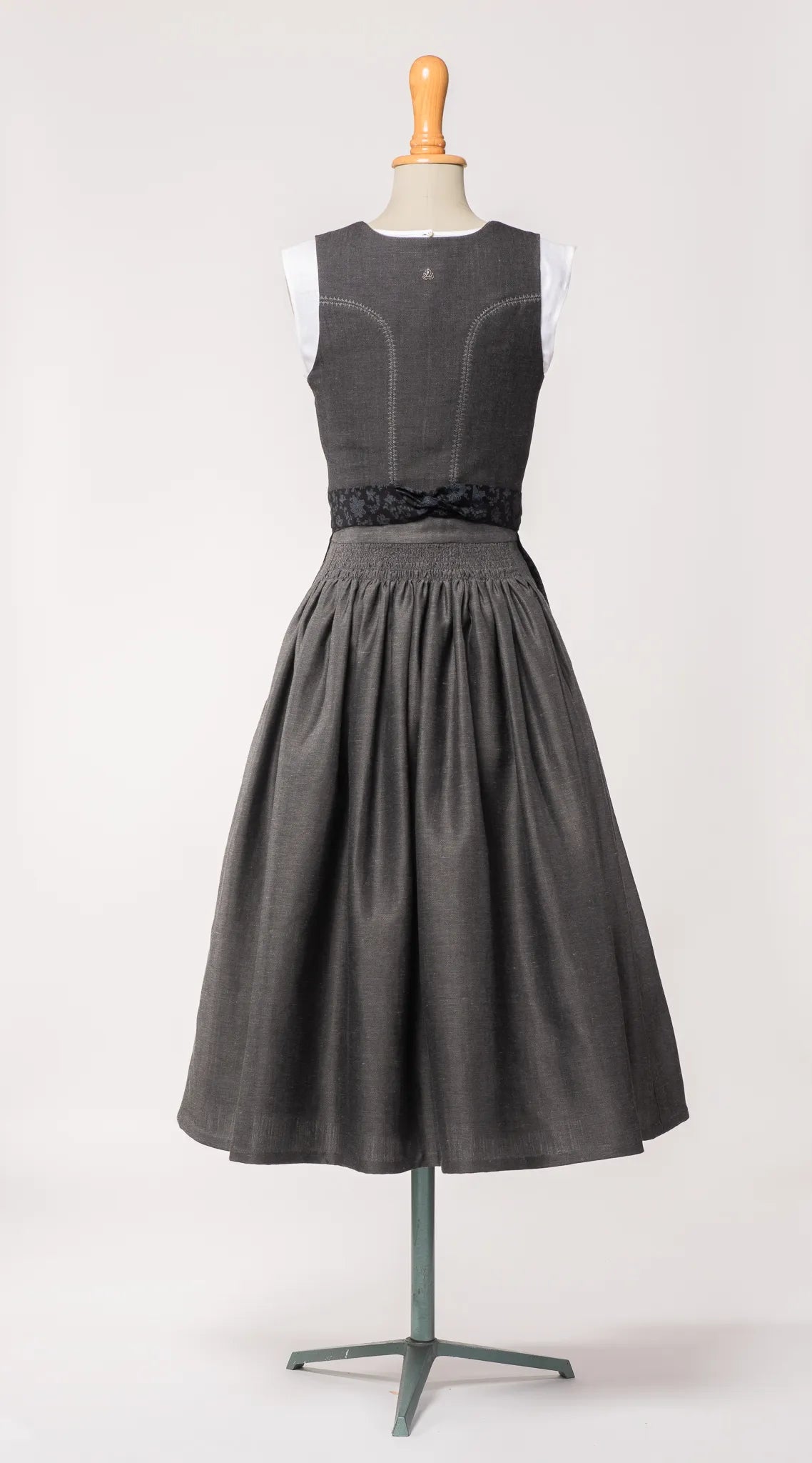 Mieder Ava und Trachtenrock Marlene aus anthrazitfarbener Leinen-Schurwolle-Mischung, kombiniert mit schwarzer Baumwollschürze – Rückansicht auf Büste, handgefertigt in München von Zirbenfux
