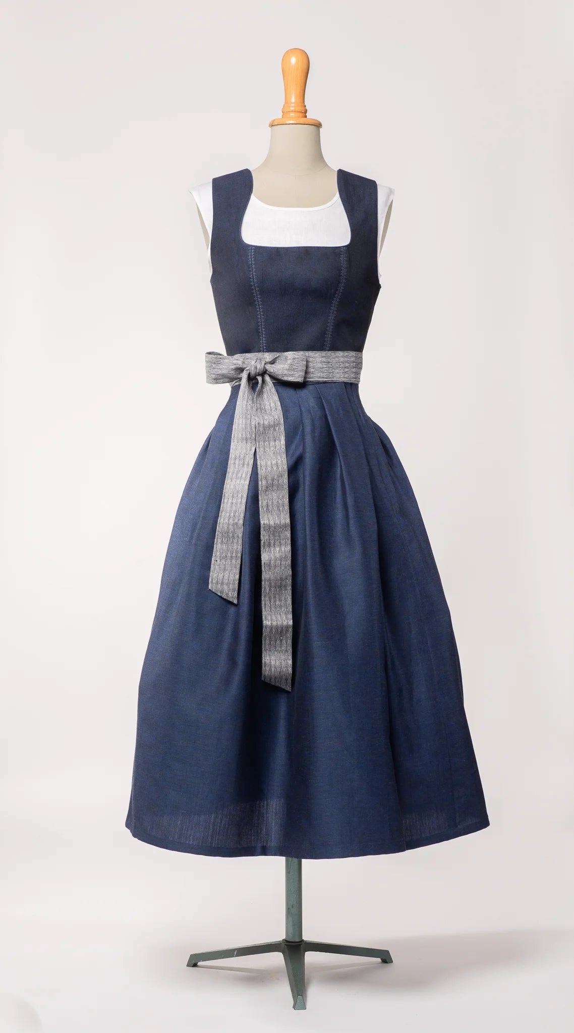 Schürzenband aus blaugrauem Bio-Leinen mit eingewebtem Muster, kombiniert mit Mieder und Rock in dunkelblau – Ansicht auf Büste, handgefertigt in München von Zirbenfux