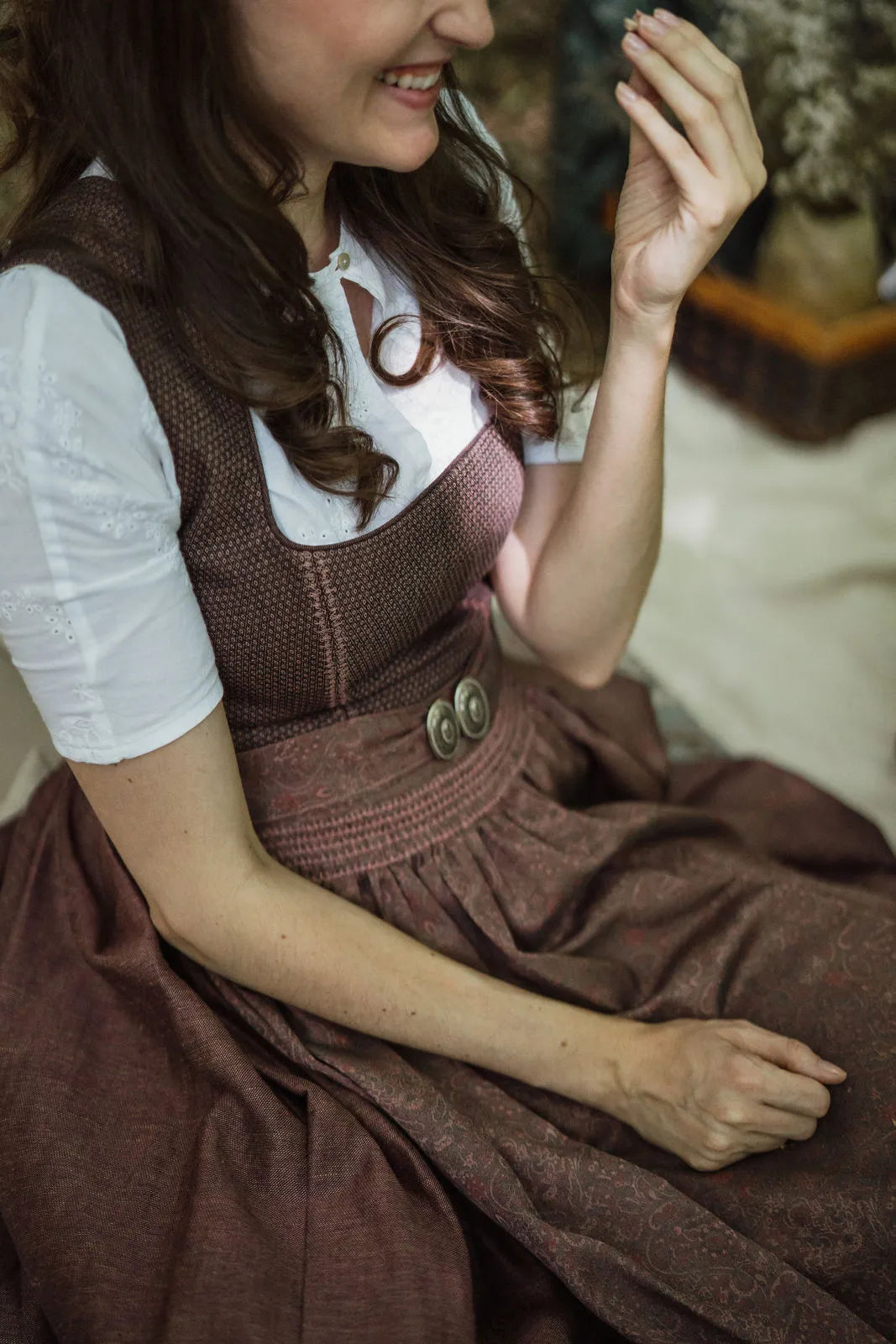 Zirbenfux Hochzeitsdirndl der Braut in Beerentönen, Detailaufnahme einer lachenden Braut beim Picknick sitzend, ungezwungen eingefangen von Zirbenfux.